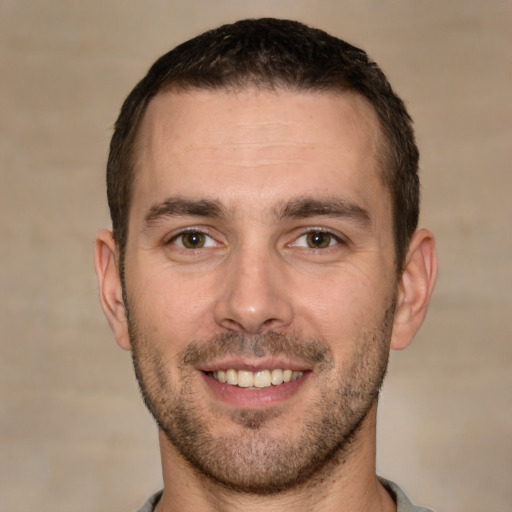 Joyful white young-adult male with short  brown hair and brown eyes