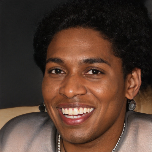 Joyful black young-adult male with short  black hair and brown eyes