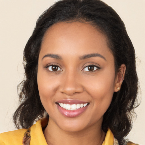 Joyful black young-adult female with medium  brown hair and brown eyes