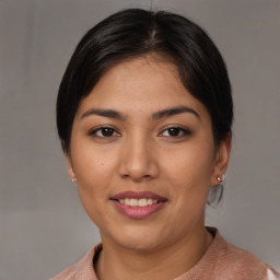 Joyful latino young-adult female with medium  brown hair and brown eyes