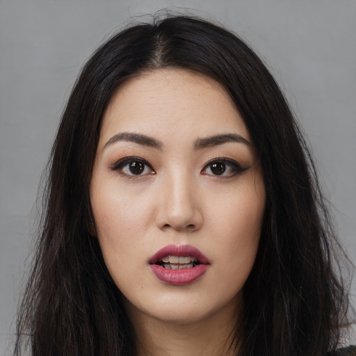 Joyful white young-adult female with long  black hair and brown eyes