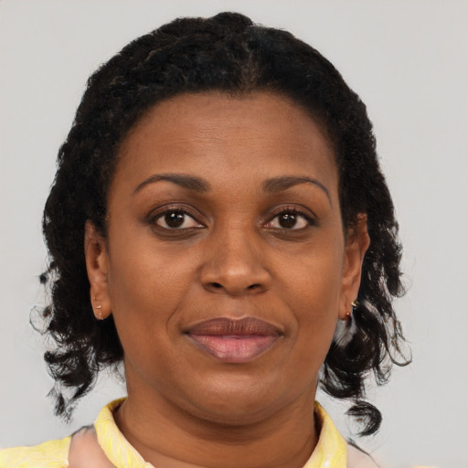 Joyful black adult female with short  brown hair and brown eyes