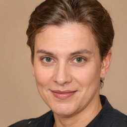 Joyful white adult female with medium  brown hair and brown eyes