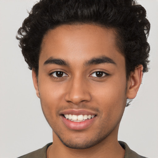 Joyful latino young-adult male with short  brown hair and brown eyes