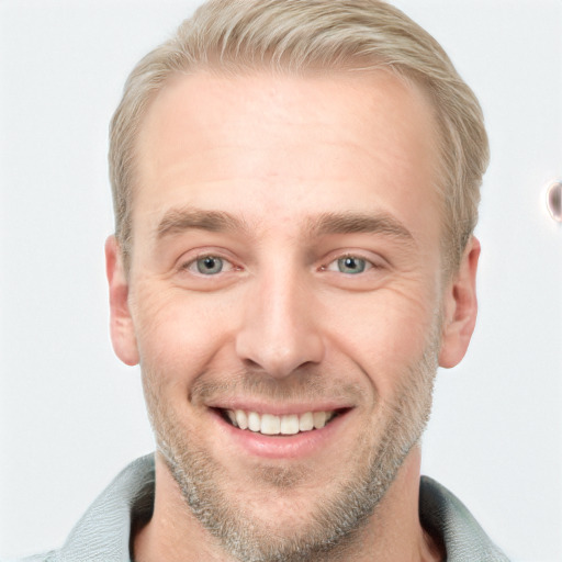 Joyful white adult male with short  brown hair and blue eyes