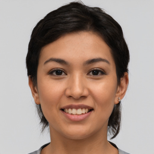 Joyful latino young-adult female with medium  black hair and brown eyes