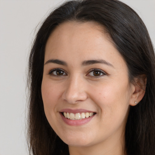 Joyful white young-adult female with long  brown hair and brown eyes