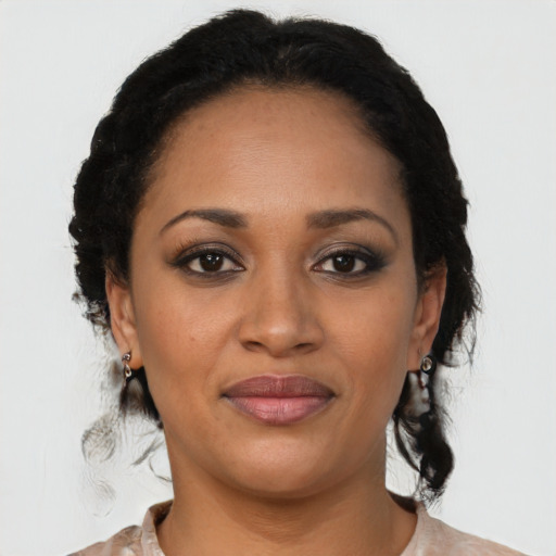 Joyful latino young-adult female with medium  black hair and brown eyes