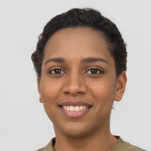 Joyful latino young-adult female with short  black hair and brown eyes