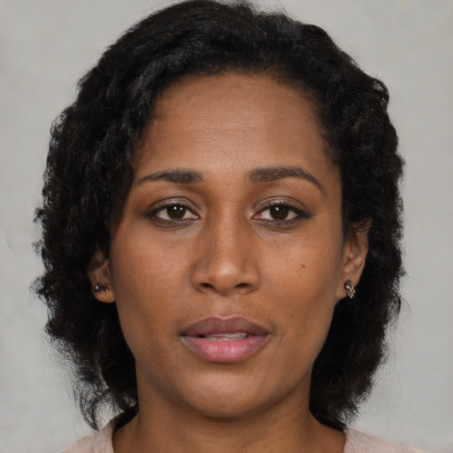 Neutral black young-adult female with medium  brown hair and brown eyes