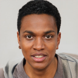 Joyful black young-adult male with short  black hair and brown eyes