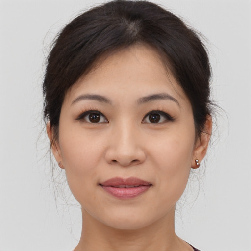 Joyful asian young-adult female with medium  brown hair and brown eyes