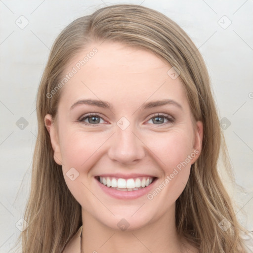 Joyful white young-adult female with long  brown hair and grey eyes