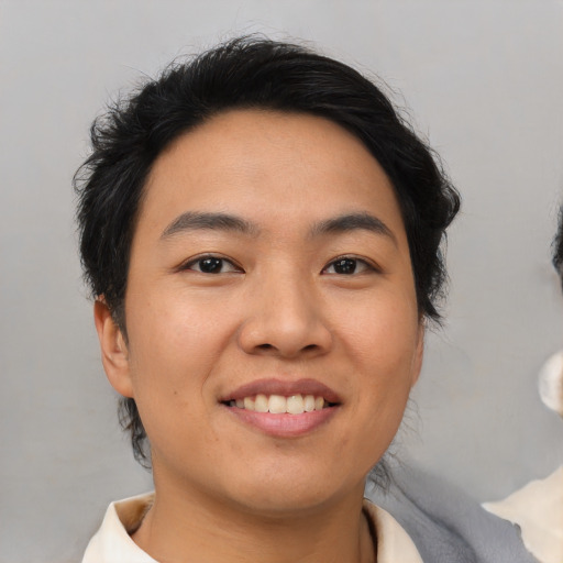 Joyful asian young-adult male with medium  brown hair and brown eyes