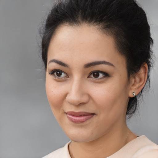 Joyful latino young-adult female with medium  black hair and brown eyes