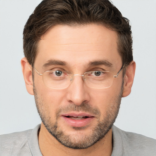 Joyful white adult male with short  brown hair and brown eyes