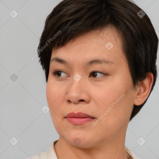 Joyful asian young-adult female with short  brown hair and brown eyes