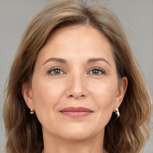 Joyful white adult female with medium  brown hair and grey eyes