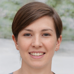 Joyful white young-adult female with medium  brown hair and grey eyes