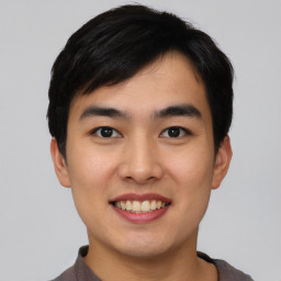 Joyful asian young-adult male with short  black hair and brown eyes