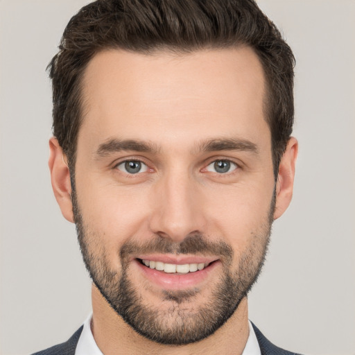 Joyful white young-adult male with short  brown hair and brown eyes