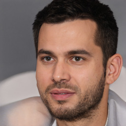 Joyful white young-adult male with short  black hair and brown eyes