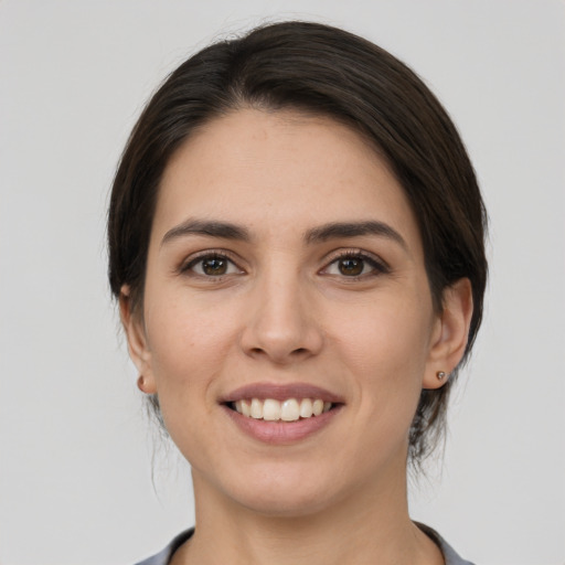 Joyful white young-adult female with medium  brown hair and brown eyes