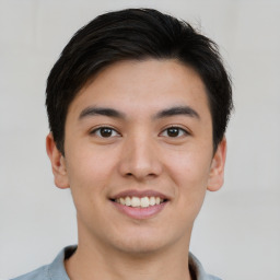 Joyful asian young-adult male with short  brown hair and brown eyes