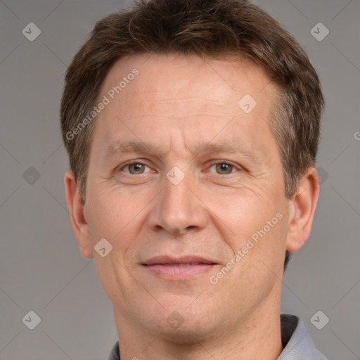 Joyful white adult male with short  brown hair and grey eyes