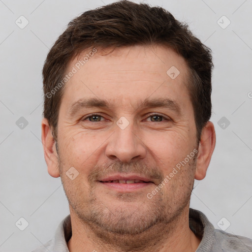 Joyful white adult male with short  brown hair and brown eyes