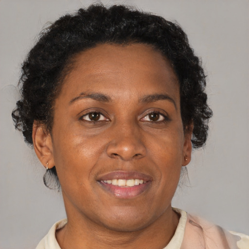 Joyful black adult female with short  brown hair and brown eyes