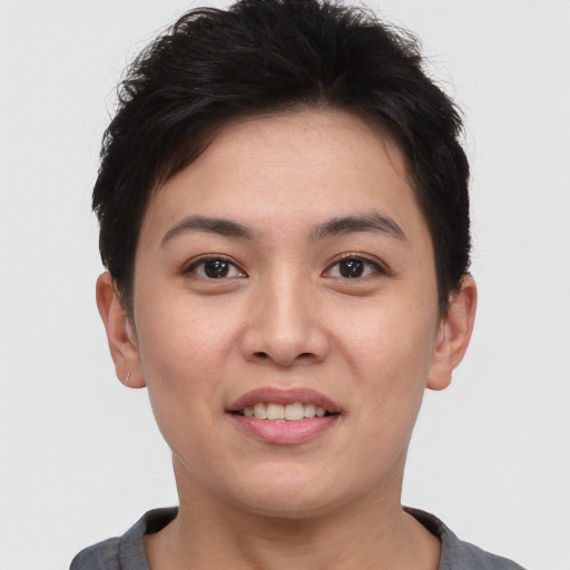Joyful white young-adult female with short  brown hair and brown eyes