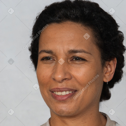 Joyful latino adult female with short  brown hair and brown eyes