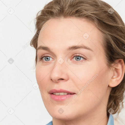 Joyful white young-adult female with medium  brown hair and blue eyes