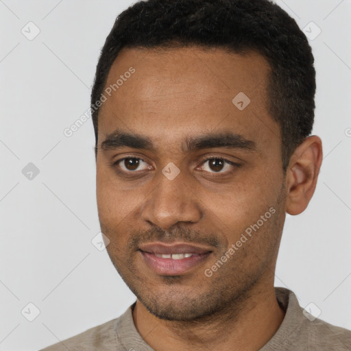 Joyful black young-adult male with short  black hair and brown eyes