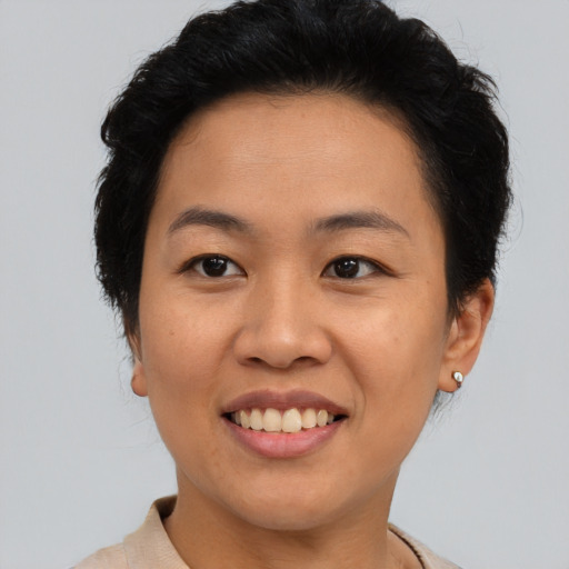 Joyful asian young-adult female with short  black hair and brown eyes