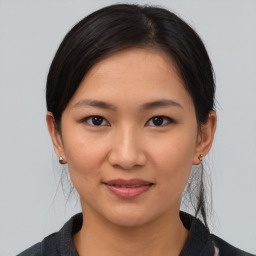 Joyful asian young-adult female with medium  brown hair and brown eyes