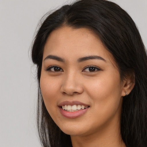 Joyful asian young-adult female with long  brown hair and brown eyes