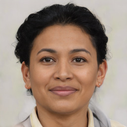 Joyful latino young-adult female with short  brown hair and brown eyes