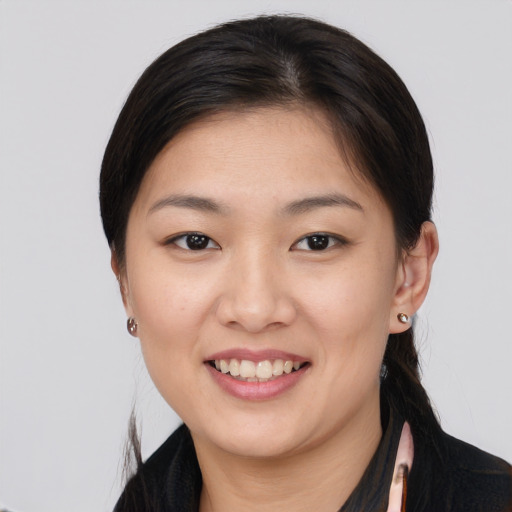 Joyful asian young-adult female with medium  brown hair and brown eyes