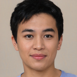 Joyful asian young-adult male with short  black hair and brown eyes