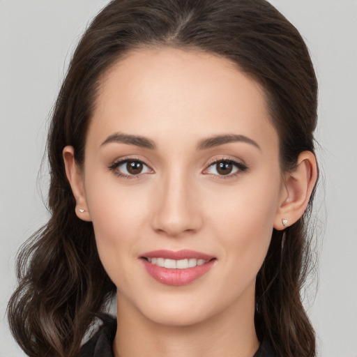 Joyful white young-adult female with long  brown hair and brown eyes