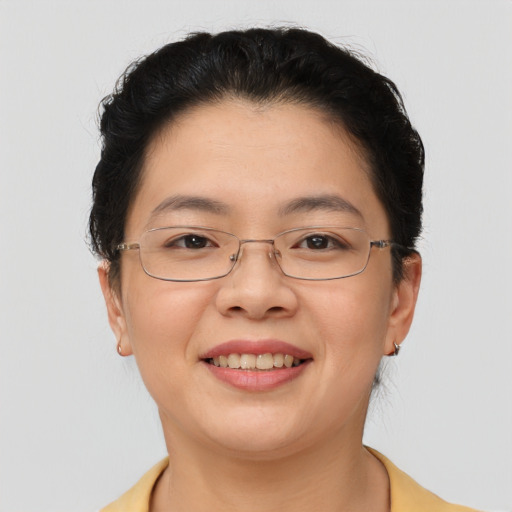 Joyful asian adult female with short  brown hair and brown eyes
