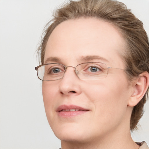 Joyful white adult female with medium  brown hair and blue eyes