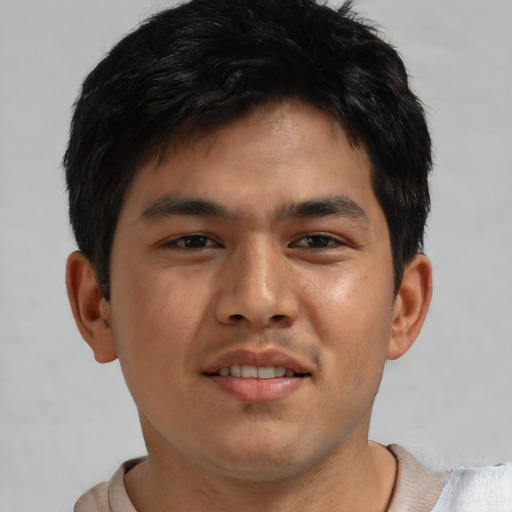 Joyful asian young-adult male with short  brown hair and brown eyes