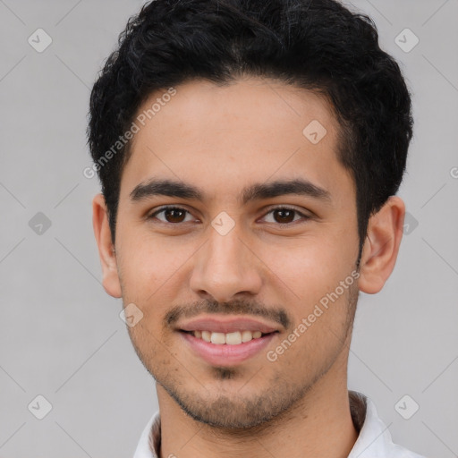 Joyful latino young-adult male with short  brown hair and brown eyes