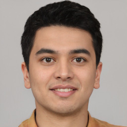 Joyful asian young-adult male with short  black hair and brown eyes