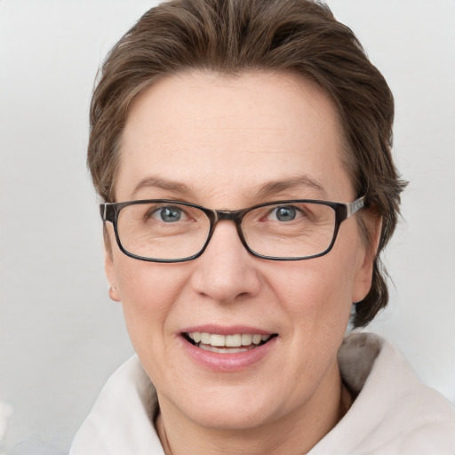 Joyful white adult female with medium  brown hair and blue eyes