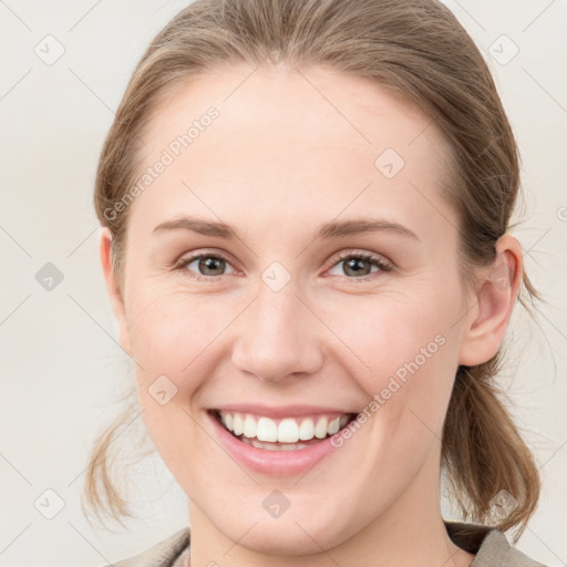 Joyful white young-adult female with medium  brown hair and blue eyes