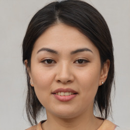 Joyful white young-adult female with medium  brown hair and brown eyes